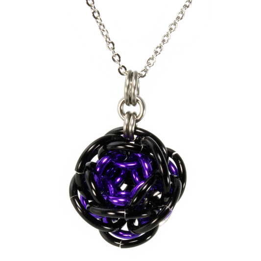 A purple and black aluminum rhosyn chainmaille pendant.